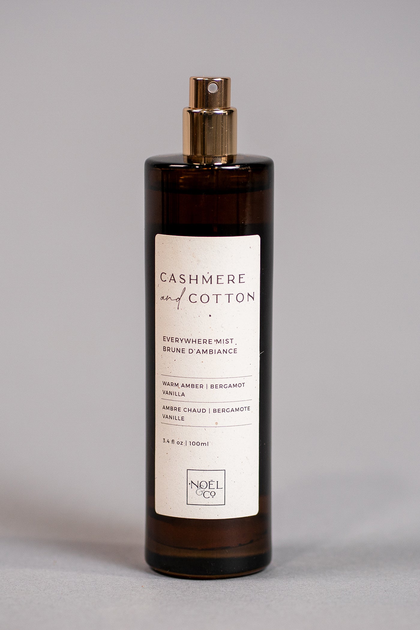 A bottle of 'Cashmere & Cotton' everywhere mist by Noël and Co, featuring a label with product details and branding on a plain background.