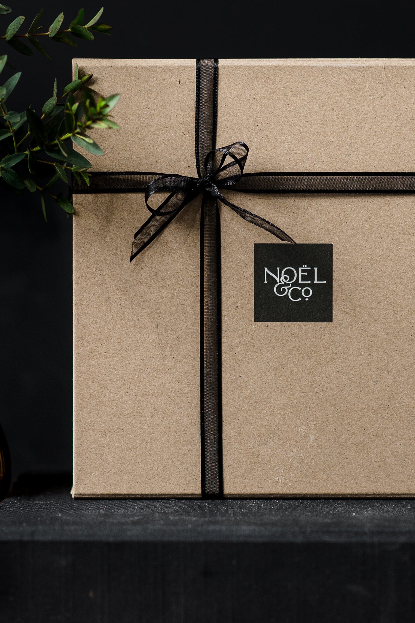 A box with a bow and the Noël & Co. logo.